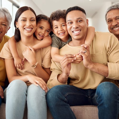 House, portrait and happy big family love enjoying quality time, gathering and having fun bonding in Colombia. Mother, father and elderly grandparents relaxing on a sofa with young children siblings.